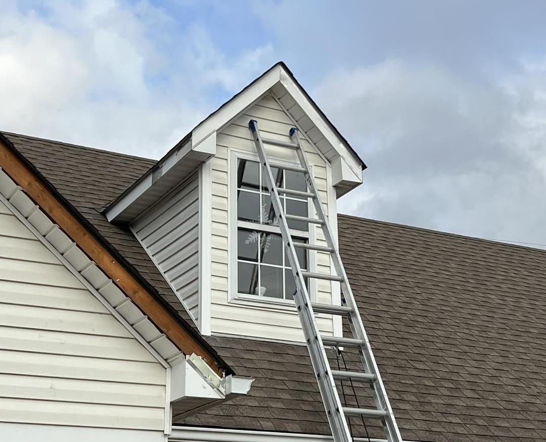 MINT Exteriors working on a house