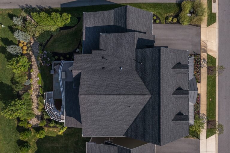 Residential roof replacement near Waxahachie,Texas. Aerial top down view of a complex hip and valley pitched roof with three dormers on a new construction home