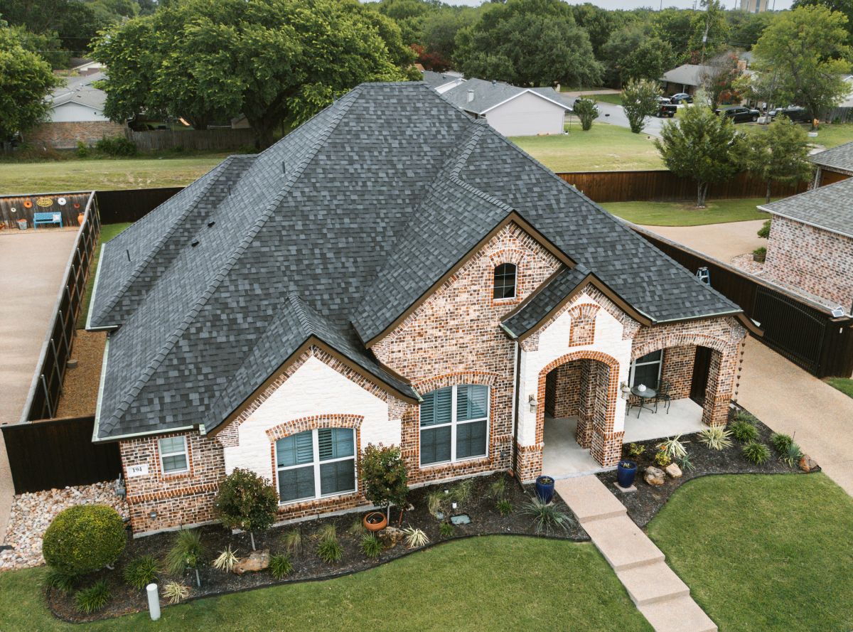 A large residential home with a new asphalt shingle roof by MINT Exteriors